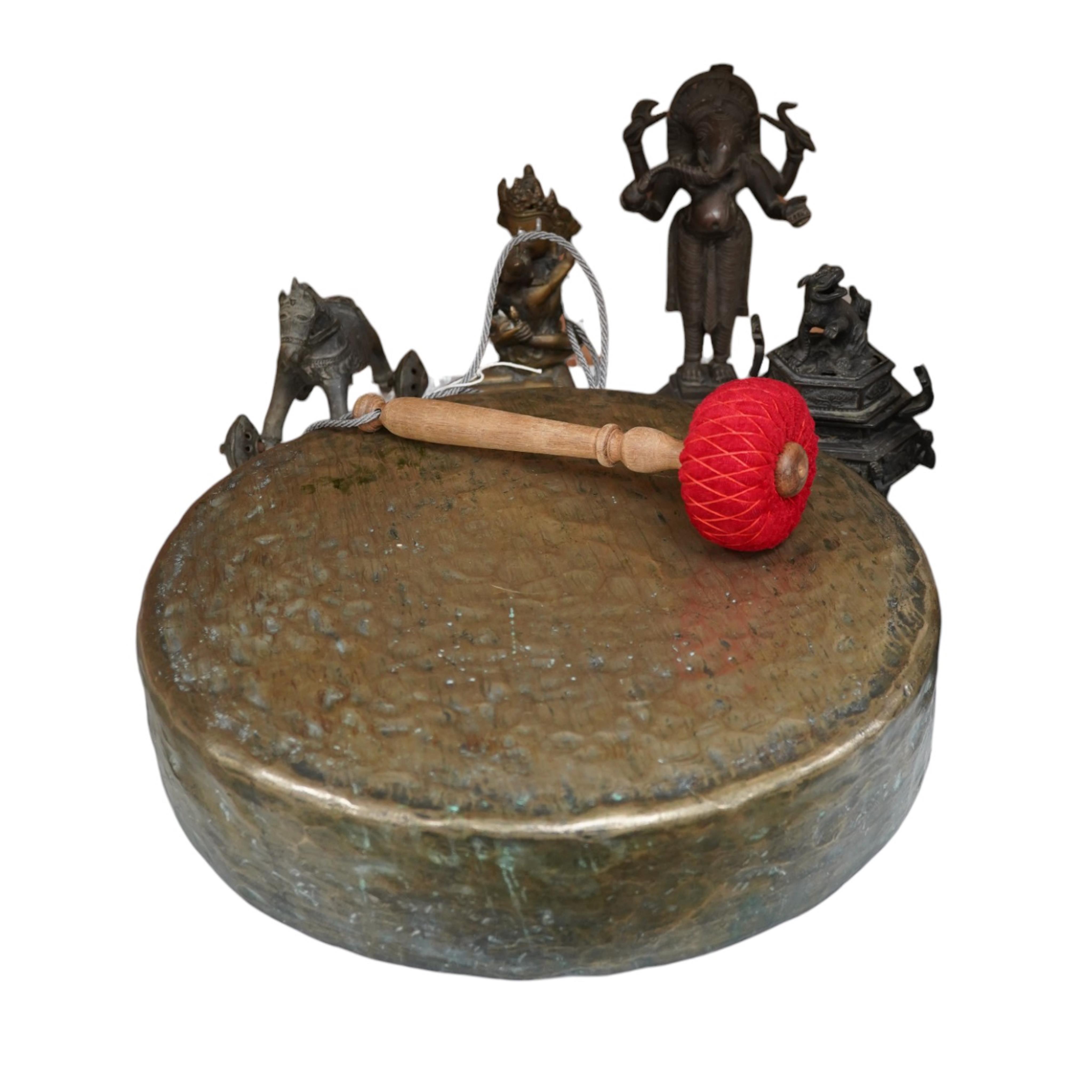 A group of four south east Asian cast bronzes and a gong with mount and beater, 40.5cm